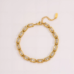 Detail of gold stainless steel bracelet with zircon inlay and lobster clasp