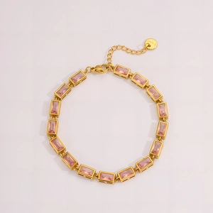Detail of pink rectangular zircon stones set in a gold stainless steel bracelet
