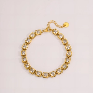 Detail view of gold stainless steel bracelet with lobster clasp and cubic zirconia stones