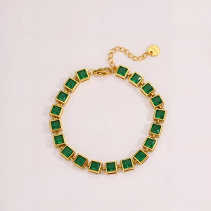 Detail of gold stainless steel bracelet featuring square green zircon stones and S.steel tag