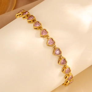 Detailed close-up of heart-shaped pink zircon bracelet with gold-plated metal inlay