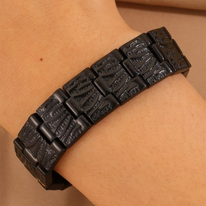 Men's wide stainless steel chain bracelet with black magnetic links and engraved patterns
