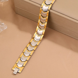 Detail of two-tone gold and silver stainless steel magnetic bracelet with V-shaped links