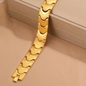 Modern 18k gold plated stainless steel bracelet with wave link pattern on a luxury box