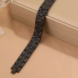 Men's matte black stainless steel link bracelet with geometric textures on elegant box