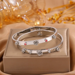 Detailed macro view of silver flower bracelets with red rhinestones on jewelry box