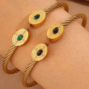 Gros plan de bracelets torsadés avec extrémités ovales en malachite et onyx noir