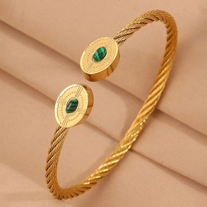 Vue détaillée d'un bracelet torsadé en or avec des embouts ovales en pierre de malachite