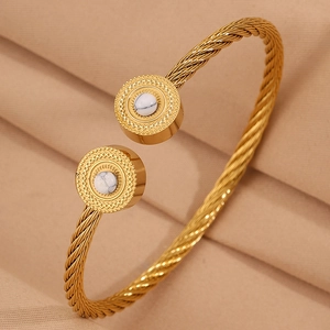 Vue macro du bracelet câble tressé doré avec pierre de marbre blanc et texture radiale
