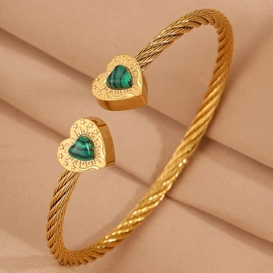Detail of twisted gold wire bracelet with heart charms and green malachite inlay