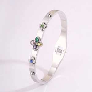 Detail of silver clover bangle with multi-color zircons and side hinge closure