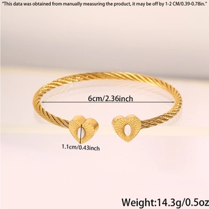 Detail view of twisted gold bracelet featuring heart charm with 6cm inner diameter
