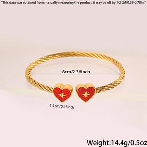 Detailed view of golden cable heart bracelet with 6cm diameter and red enamel charms