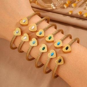 Minimalist twisted gold steel cable bangles with heart charms and colorful gemstone inlays