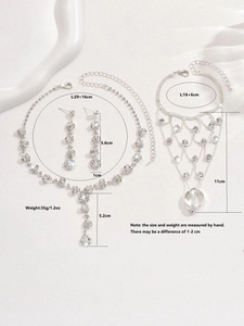Detailed view of silver rhinestone jewelry set including necklace earrings and hand chain