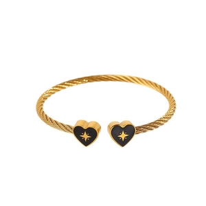 Gold cable wire open bangle featuring black heart charms and engraved star patterns