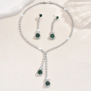 Detalle del conjunto de collar y pendientes de plata con piedras verde esmeralda y circón