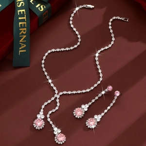 Detalle del conjunto de joyas con circón rosa, collar y pendientes en caja de terciopelo