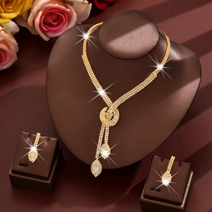 Elegant gold bridal jewelry set with sparkling rhinestones and teardrop pendants