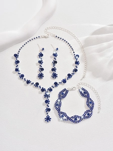Macro view of crystal bridal jewelry set with dark blue rhinestones and silver alloy base