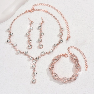 Detailed view of rose gold bridal jewelry set with sparkling rhinestones and lobster clasps
