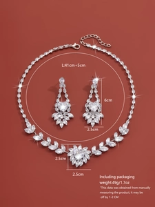 Macro shot of silver zircon jewelry set with heart stones on deep red background