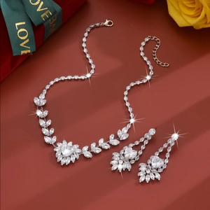Macro shot of silver zircon jewelry set with marquise stones on a deep red background