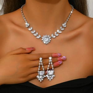 Close-up of sparkling heart zircon jewelry set with vine necklace and drop earrings