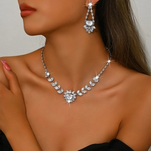 Detailed view of luxury bridal jewelry set with heart-cut zircons worn by a model