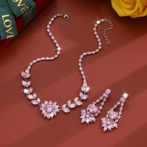 Macro shot of silver jewelry set with pink zircons on a dark red gift background