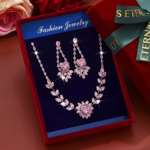 Pink heart zircon necklace and earrings set showcased in a red velvet gift box with roses