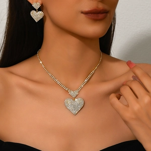 Detalle de collar con colgante de corazón de cristal y pendientes puestos