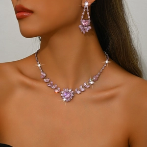Close-up of model wearing pink zircon floral necklace and heart earrings in white gold finish