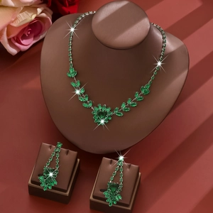 Close-up of zircon jewelry set with marquise cut green stones on a display stand