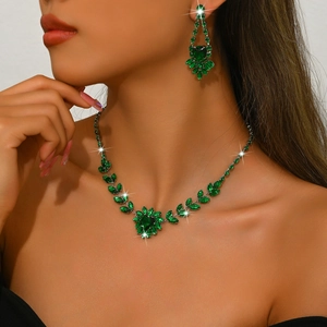 Close-up of green zircon jewelry set on model featuring vine leaves and floral design