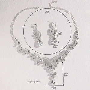 Close-up of sparkling bridal jewelry set with pear-shaped rhinestones and silver finish