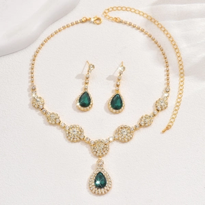 Detailed view of luxury zircon jewelry set with emerald green waterdrop pendants