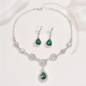 Macro detail of geometric zircon necklace set with emerald pear cut gemstones