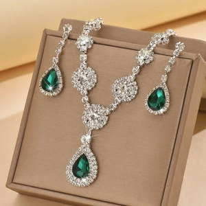 Detail of emerald green teardrop jewelry set with zircon necklace and earrings