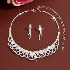 Detail of silver tassel jewelry set with marquise-cut rhinestones on necklace and earrings
