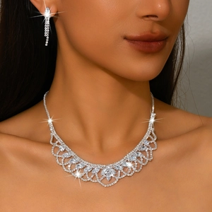 Elegant silver jewelry set with tassel earrings and zircon necklace on a model