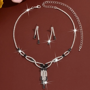 Detail of luxury rhinestone necklace set with black gems and silver fringe tassels