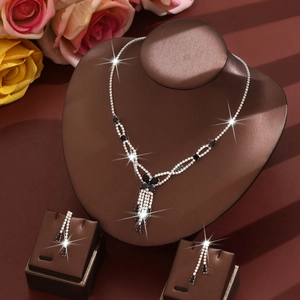 Elegant vintage silver necklace and teardrop earrings set with black and white rhinestones