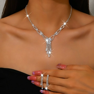 Detail of silver tassel necklace and earring set with shimmering rhinestone fringe