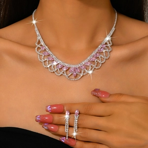 Silver necklace and earrings set with pink marquise-cut crystals on model