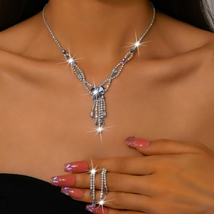 Detail shot of elegant butterfly jewelry set with rhinestones and tassel necklace on model