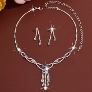 Macro detail of silver necklace set with purple gems and sparkling white rhinestones