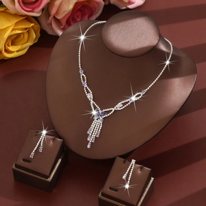 Luxurious silver jewelry set featuring purple flower necklace and long fringe earrings