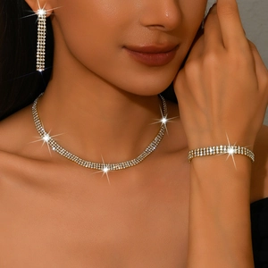 Close-up of elegant gold plated jewelry set with sparkling rhinestones on a model