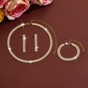 Detailed view of luxury gold rhinestone jewelry set with necklace earrings and bracelet